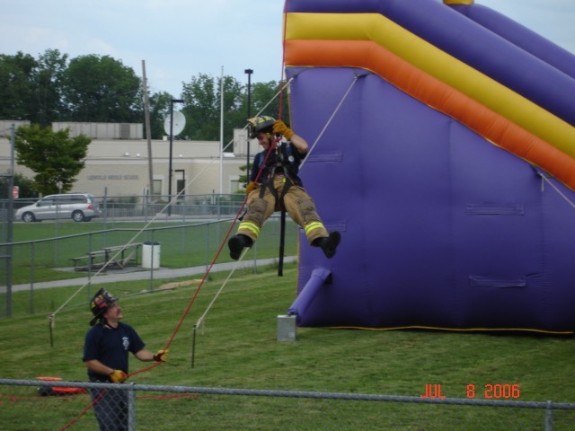 Uwchlan Township Day 07-08-2006.
Chief Engineer Norwood holds the line for FF Esterlis.