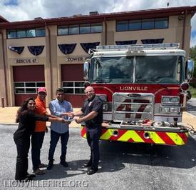 Kerala Members presenting a check to the Lionville Fire Company.